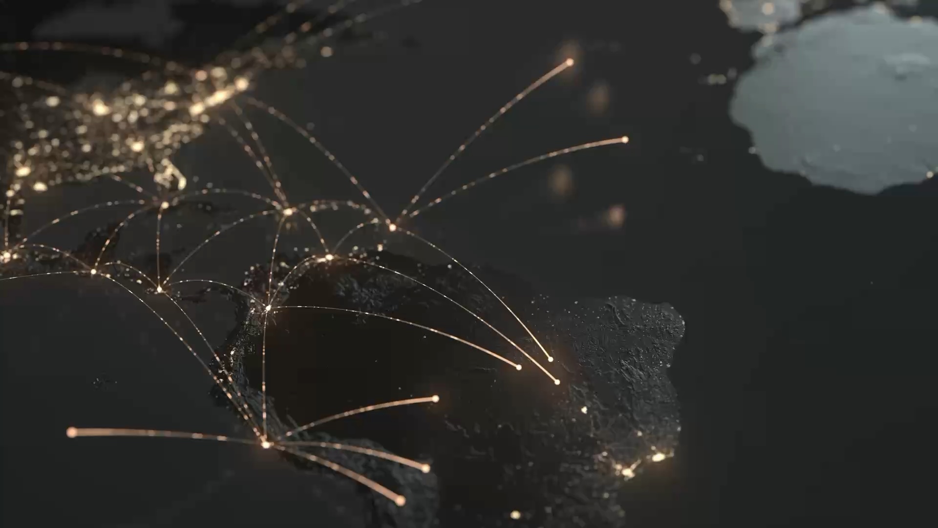 A night view of the earth from orbit, city lights across North America and Europe joined by fine transatlantic arcs.